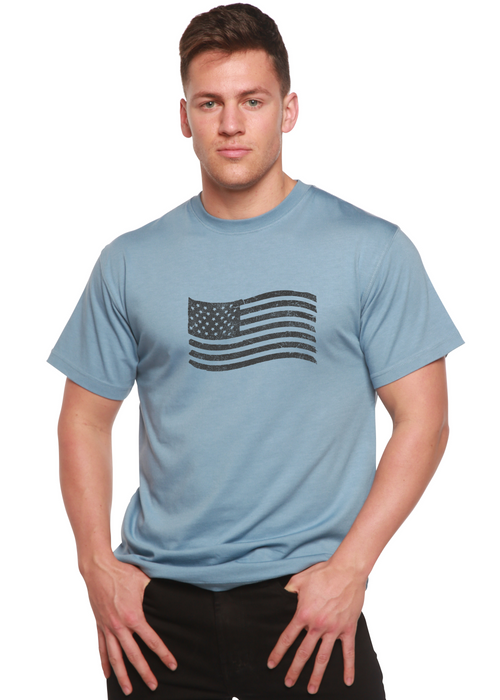 Man wearing a light blue t-shirt with an American flag design on a white background