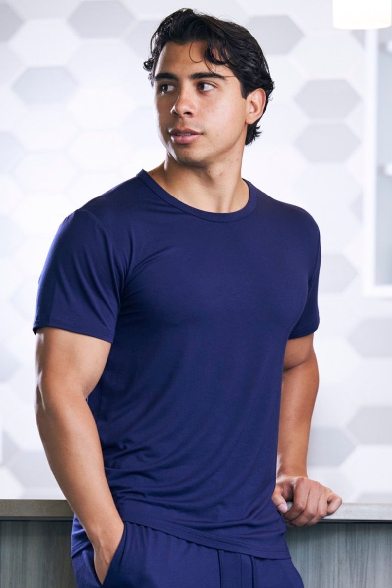 Man wearing a blue athletic outfit against a light background