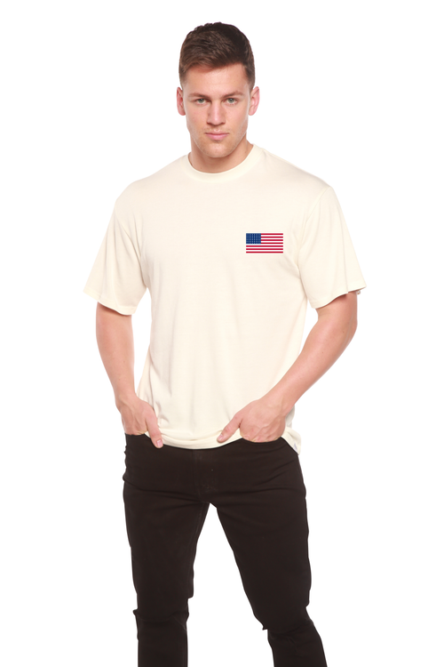 Man wearing a beige t-shirt with an American flag patch on a white background
