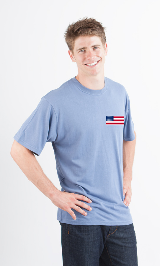 Man wearing a light blue t-shirt with an American flag patch on a white background