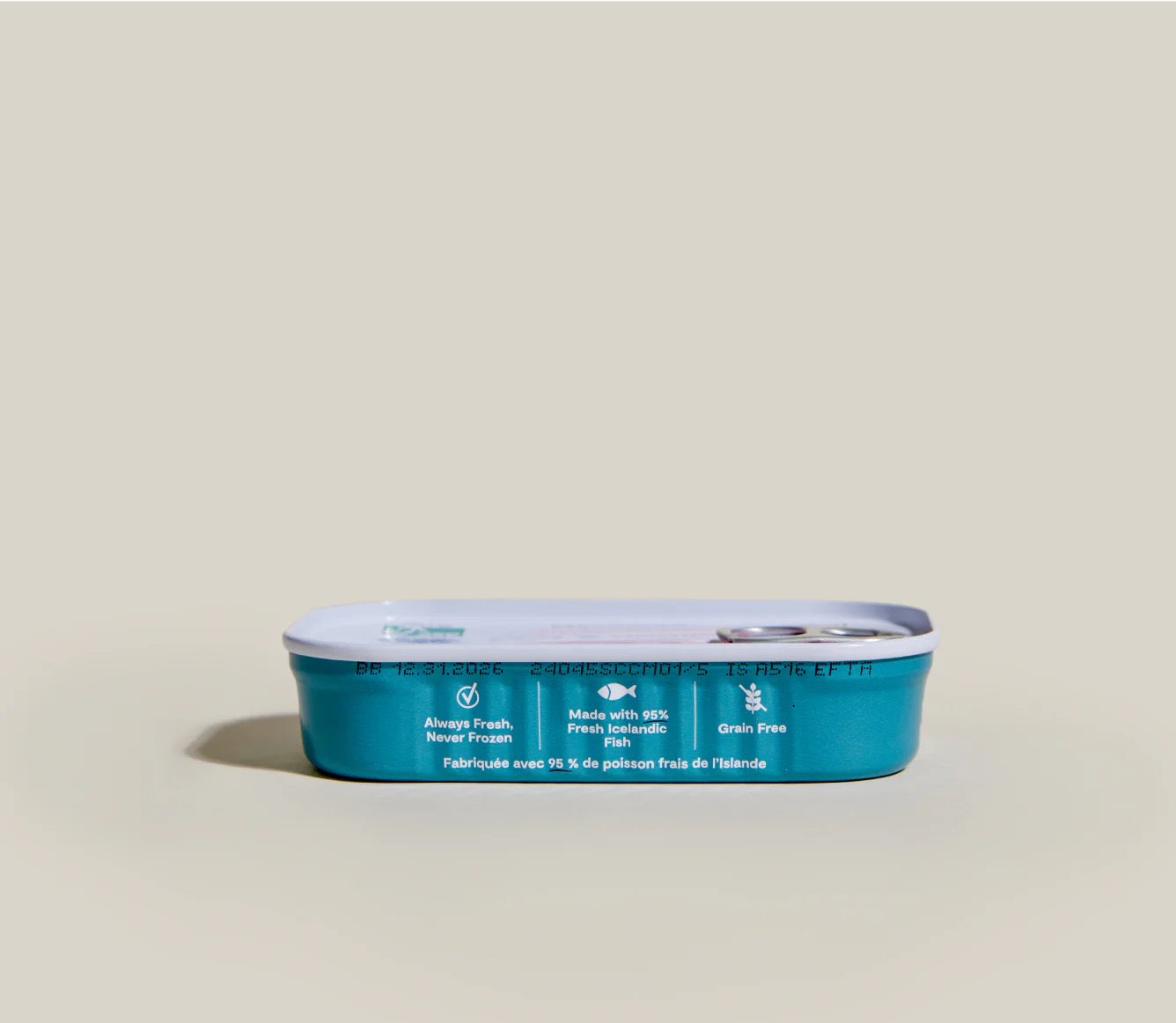 Blue pet food can with white label on a beige background