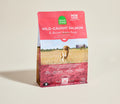 Dog food package with a red label featuring a dog and field on a beige background