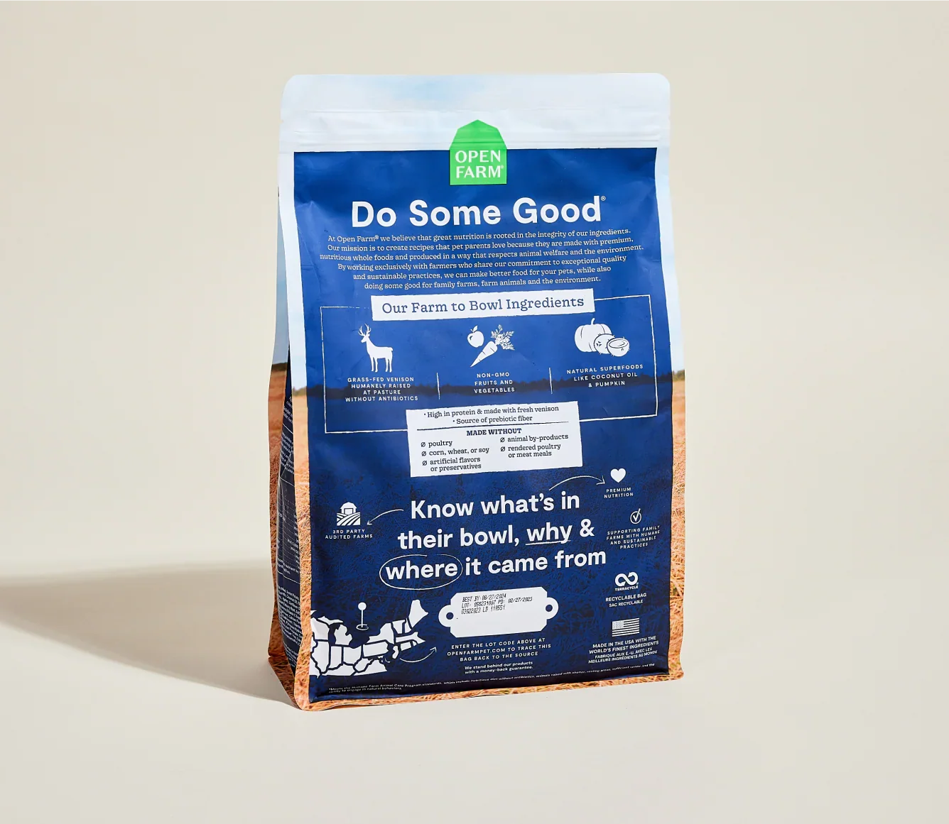 Open Farm pet food bag with blue label on a beige background