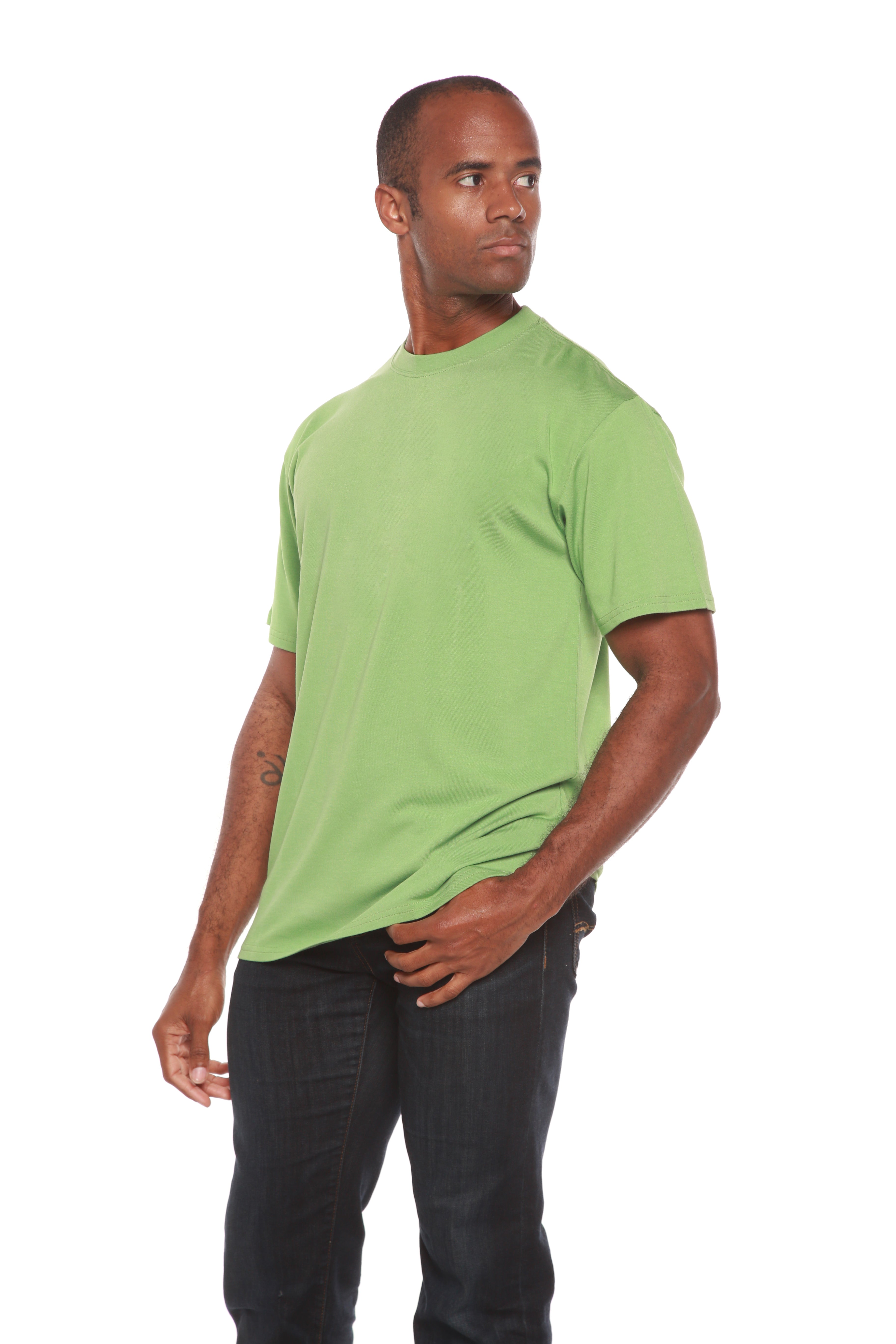 Man wearing a green t-shirt and black pants on a white background