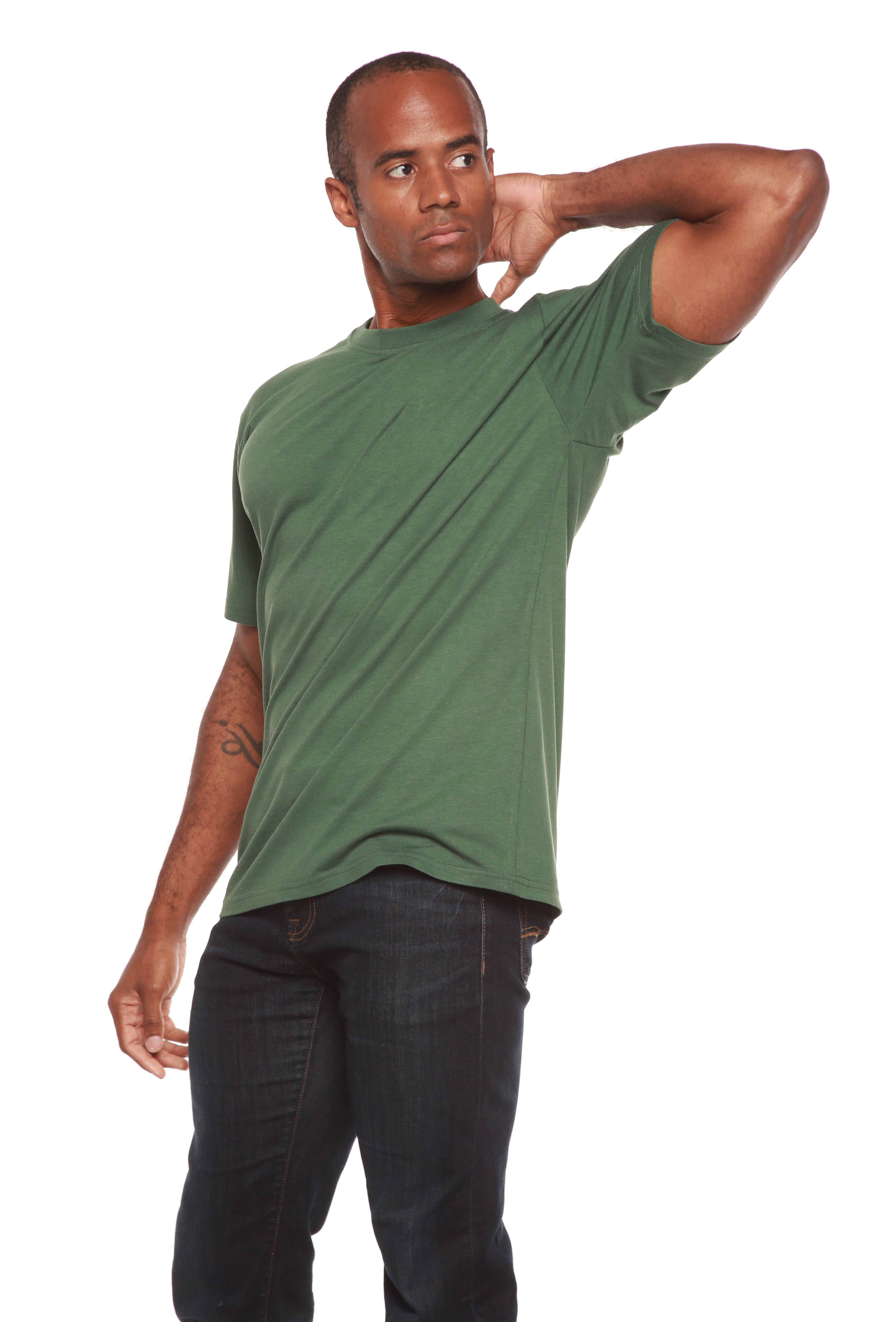 Man wearing a green t-shirt and dark jeans on a white background