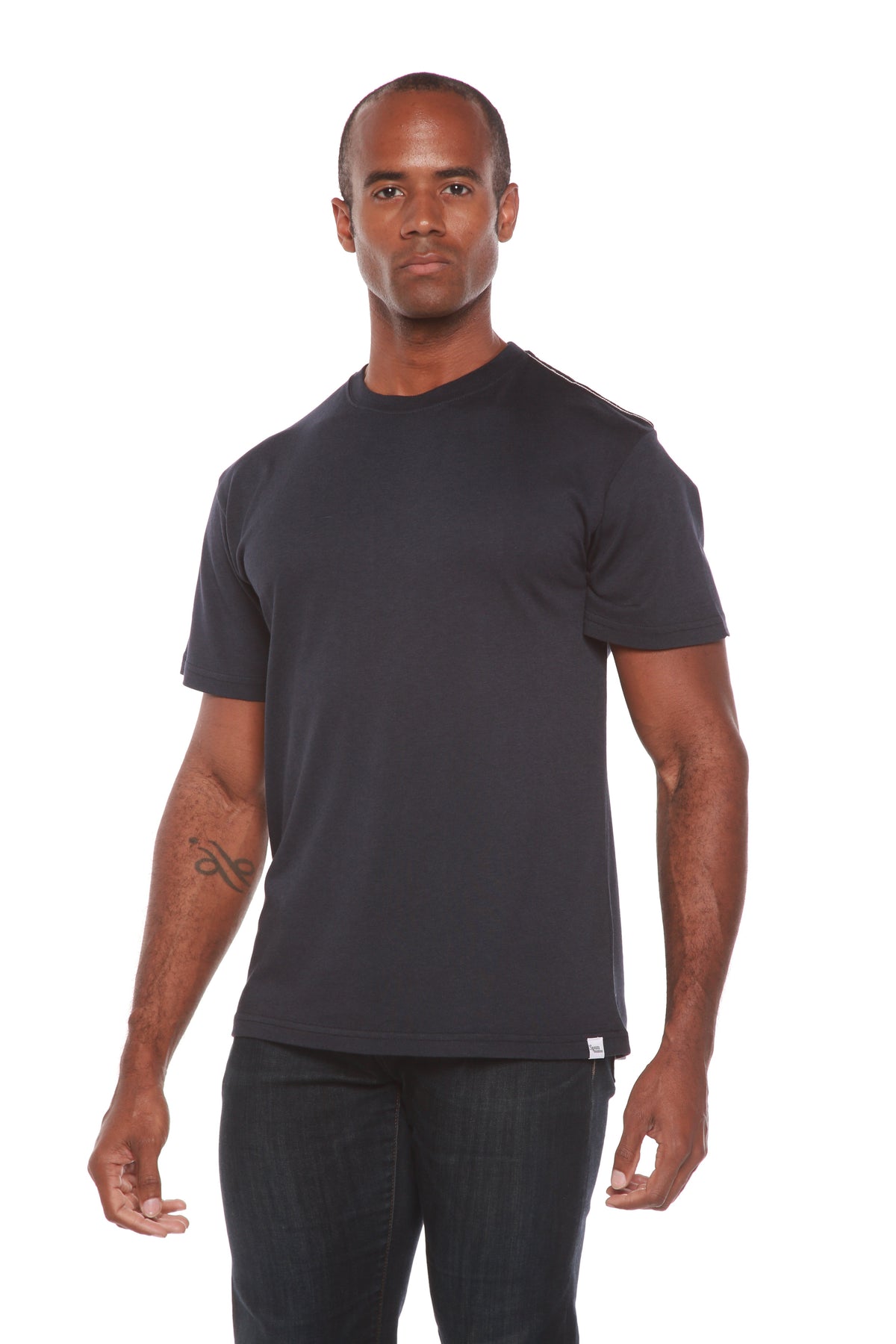 Man wearing a black t-shirt and dark pants on a white background